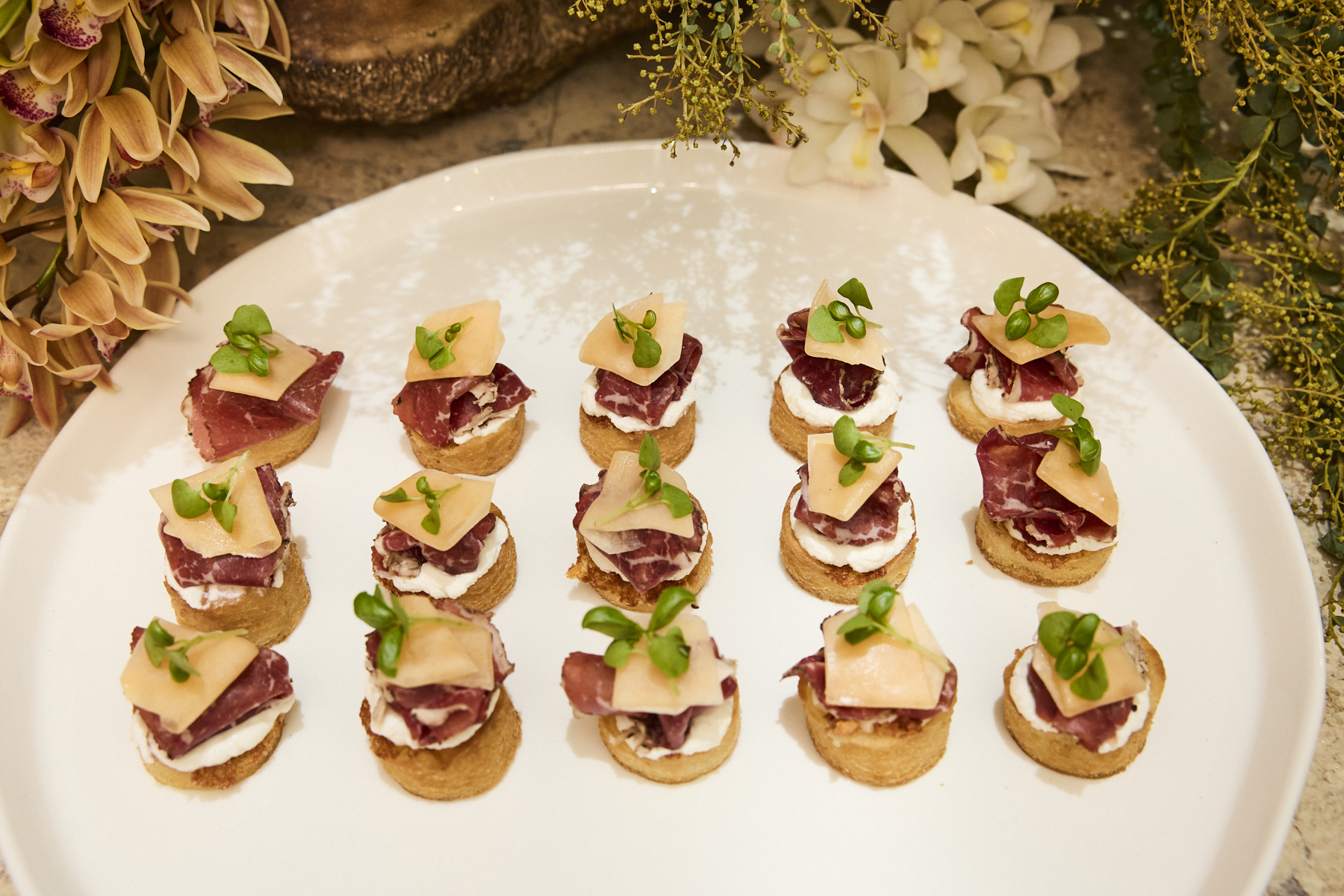 Platter of exquisite canapés made of pizza fritto, wagyu bresaola and melon.